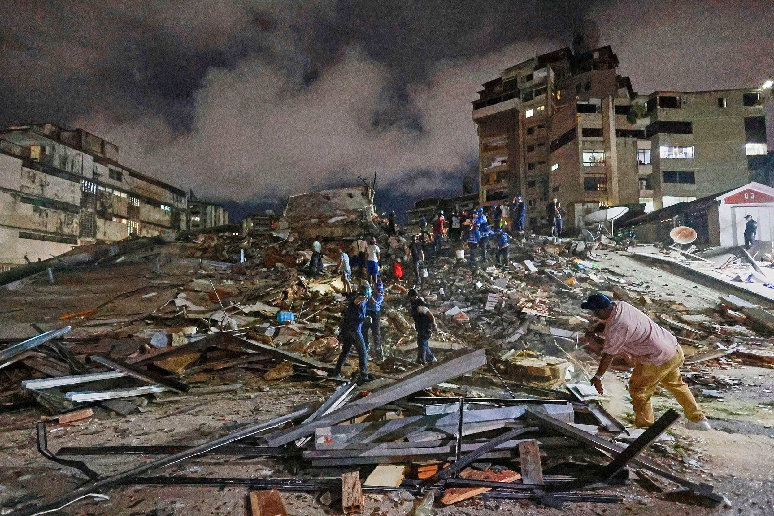 Rescue teams and residents among debris after an emergency in Venezuela